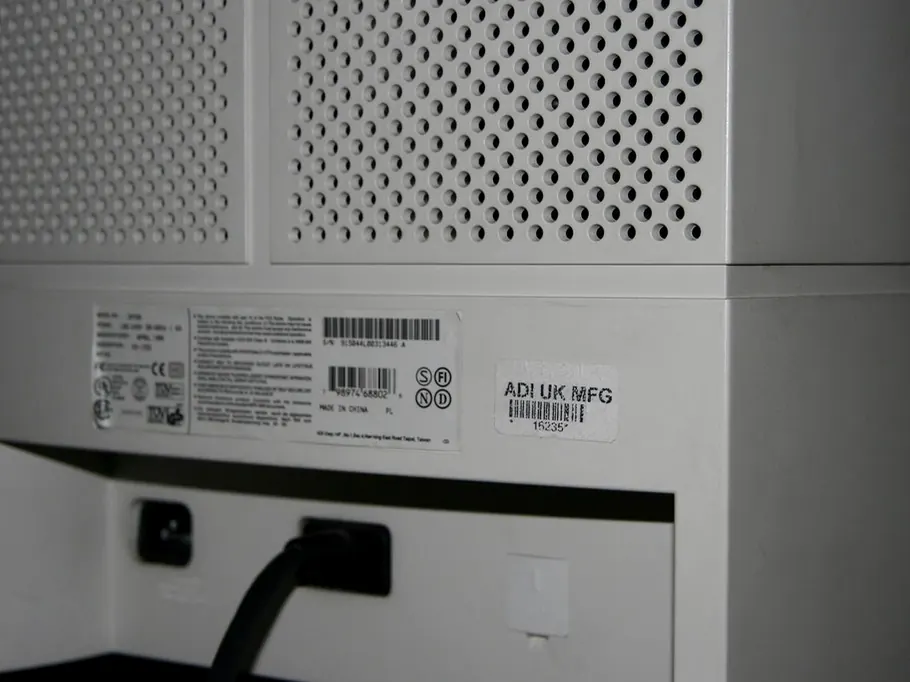 Rear panel of a device showing its manufacturer label, barcode and serial number