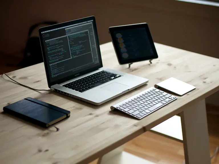 A laptop and accessories on a home office desk